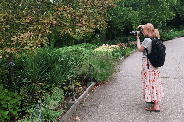 Stacey Natal photographing in a garden